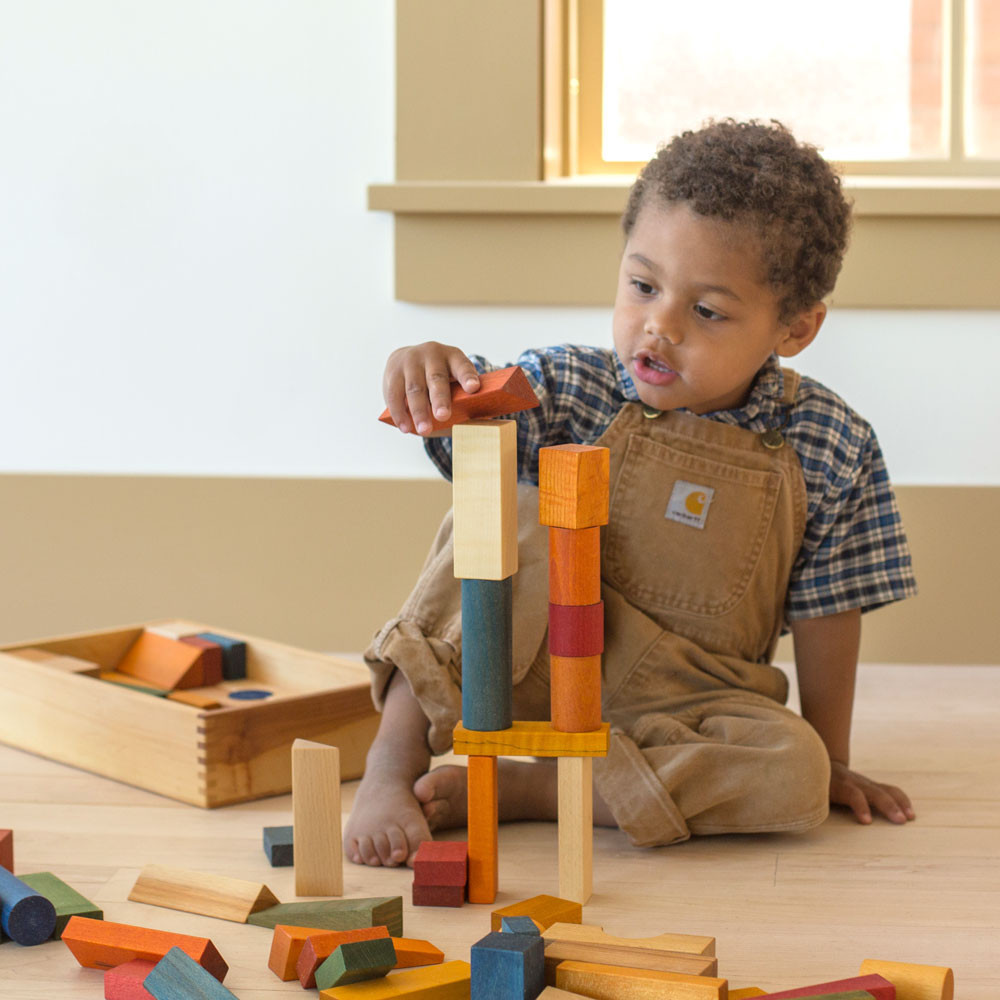 Children engaged in creative block play with colorful building blocks